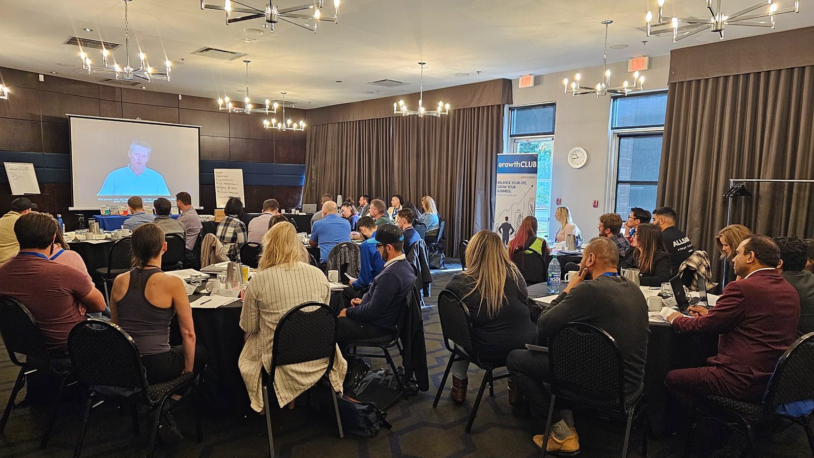 A GrowthCLUB room of business owners watching a presentation